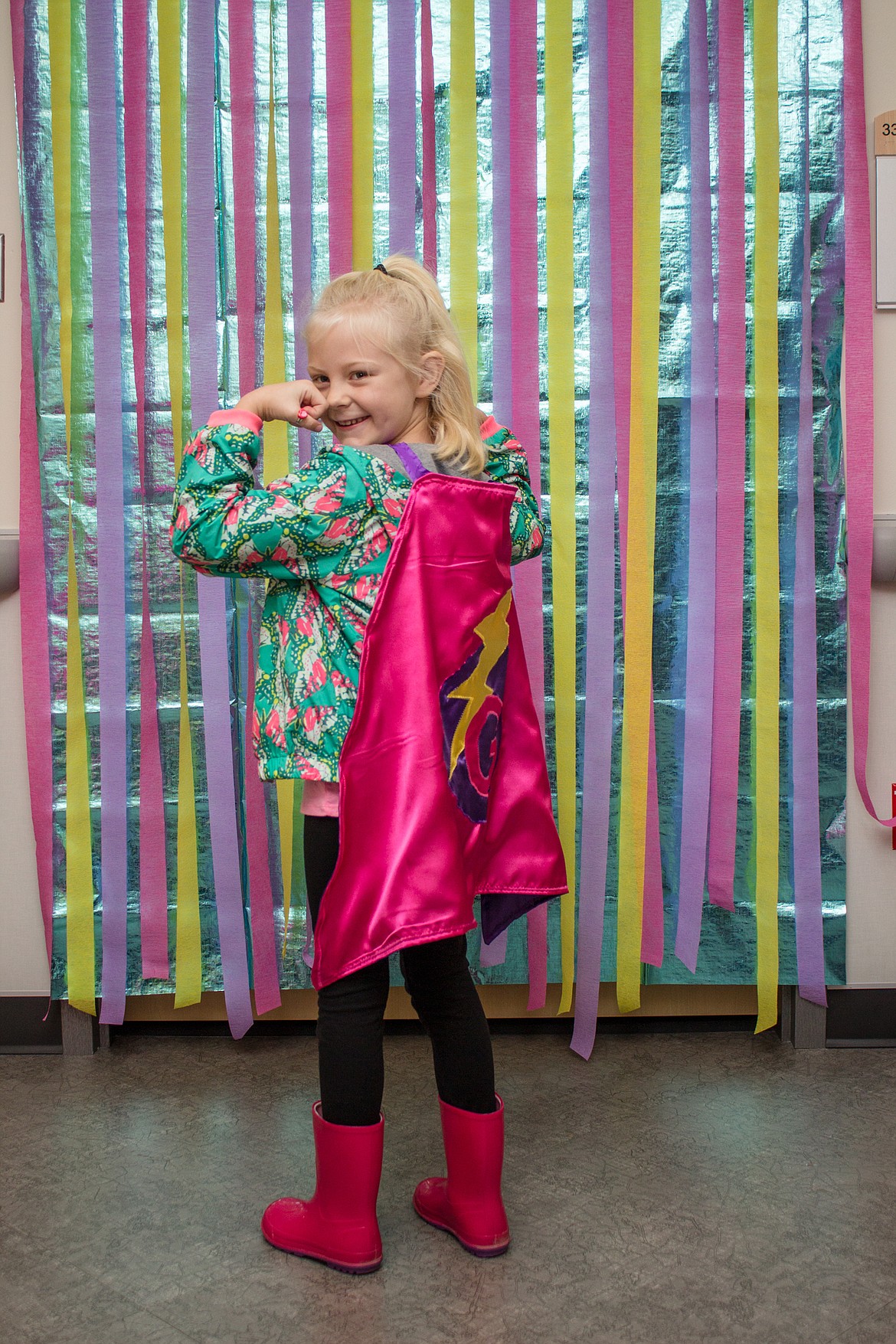 Gemma Farrell, 6, shows how strong she is Wednesday after her final IV treatment at Kootenai Health for systemic juvenile rheumatoid arthritis, a rare condition that affects her joints. (ANDREA NAGEL/Kootenai Health)