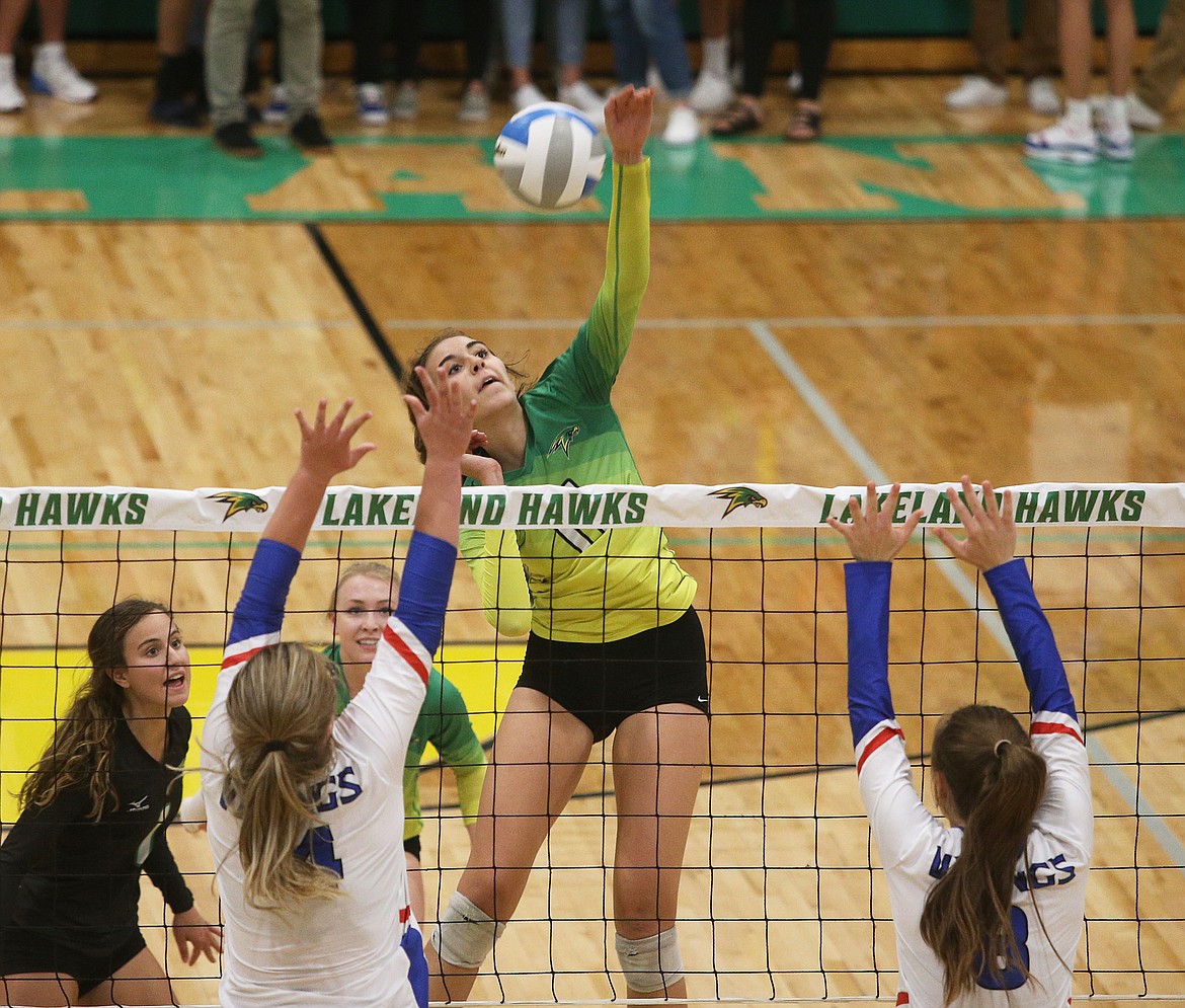 Lakeland High&#146;s Katy Ryan spikes the ball between Coeur d&#146;Alene&#146;s Lauryn Fuller (4) and Kate Phillips (8) during Thursday&#146;s volleyball match in Rathdrum.