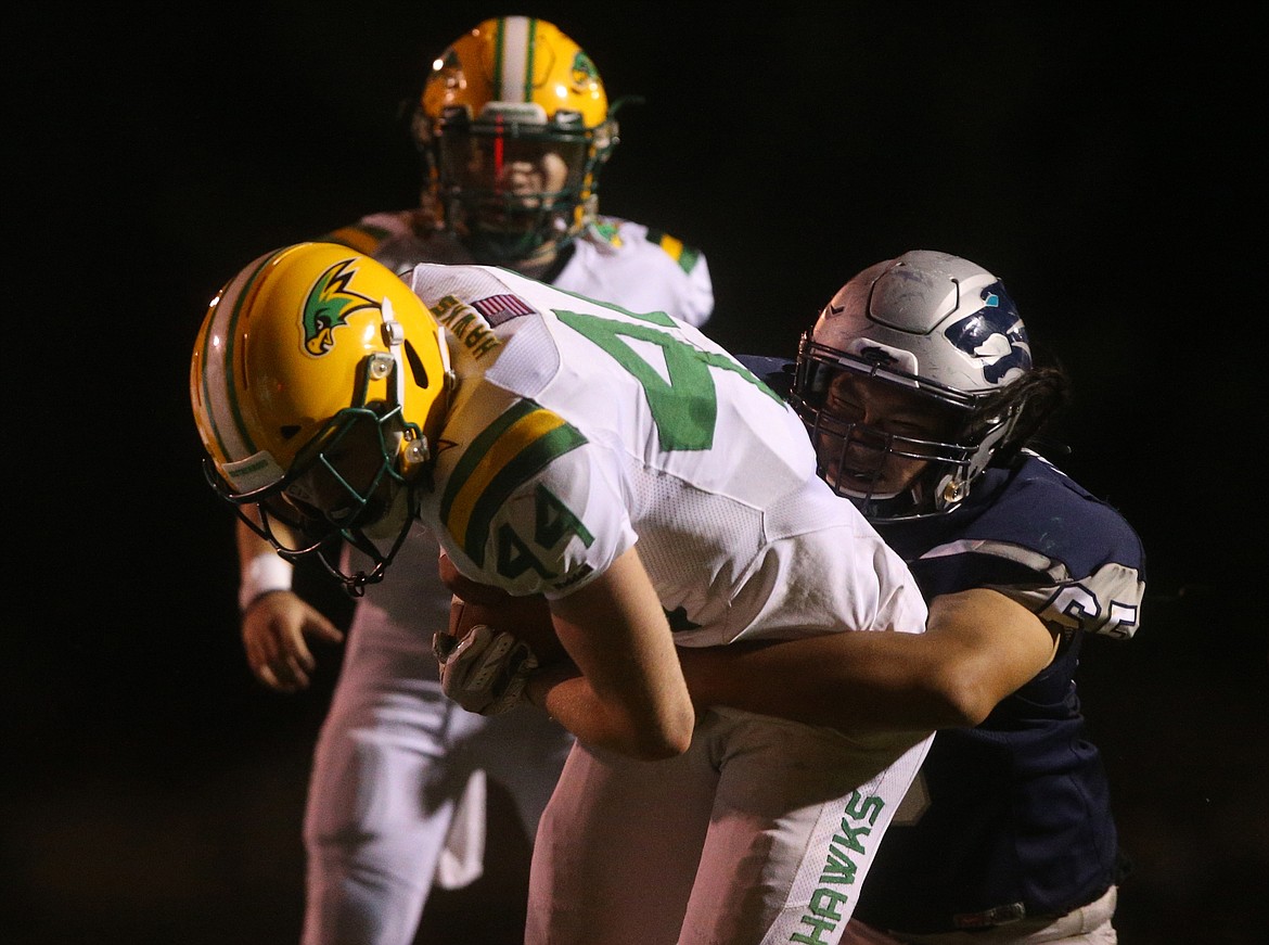 Lakeland High running back Logan James rushes upfield as Lake City&#146;s Patrick Lasarte makes the tackle during Friday night&#146;s game at Lake City.