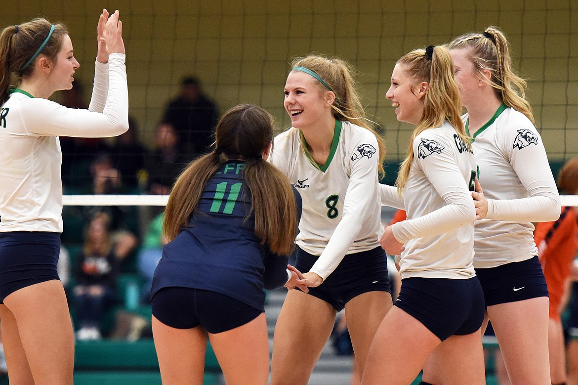 From left, Glacier's Sidney Gulick (1), Alyssa AuClaire (11), Aubrie Rademacher (8), Kaylee Fritz (5) and Kynzie Mohl (10) celebrate after a point against Flathead during crosstown volleyball at Glacier High School on Thursday. (Casey Kreider/Daily Inter Lake)