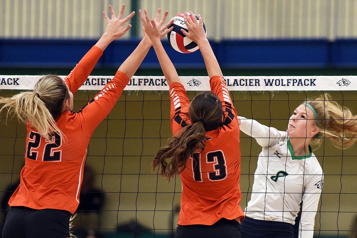 Glacier's Aubrie Rademacher (8) goes for a kill against Flathead's Julia Burden (22) and Maddi Chavez (13) during crosstown volleyball at Glacier High School on Thursday. (Casey Kreider/Daily Inter Lake)