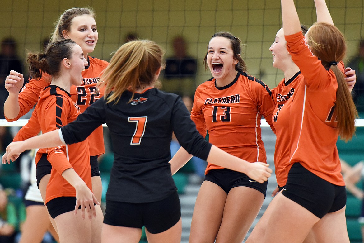 From left, Flathead's Maddie Lindbom (6), Julia Burden (22), Alayna Creekmore (7), Maddi Chavez (13), Kenna Johnson (3) and Mayson Moore (17) celebrate after a point against Glacier during crosstown volleyball at Glacier High School on Thursday. (Casey Kreider/Daily Inter Lake)