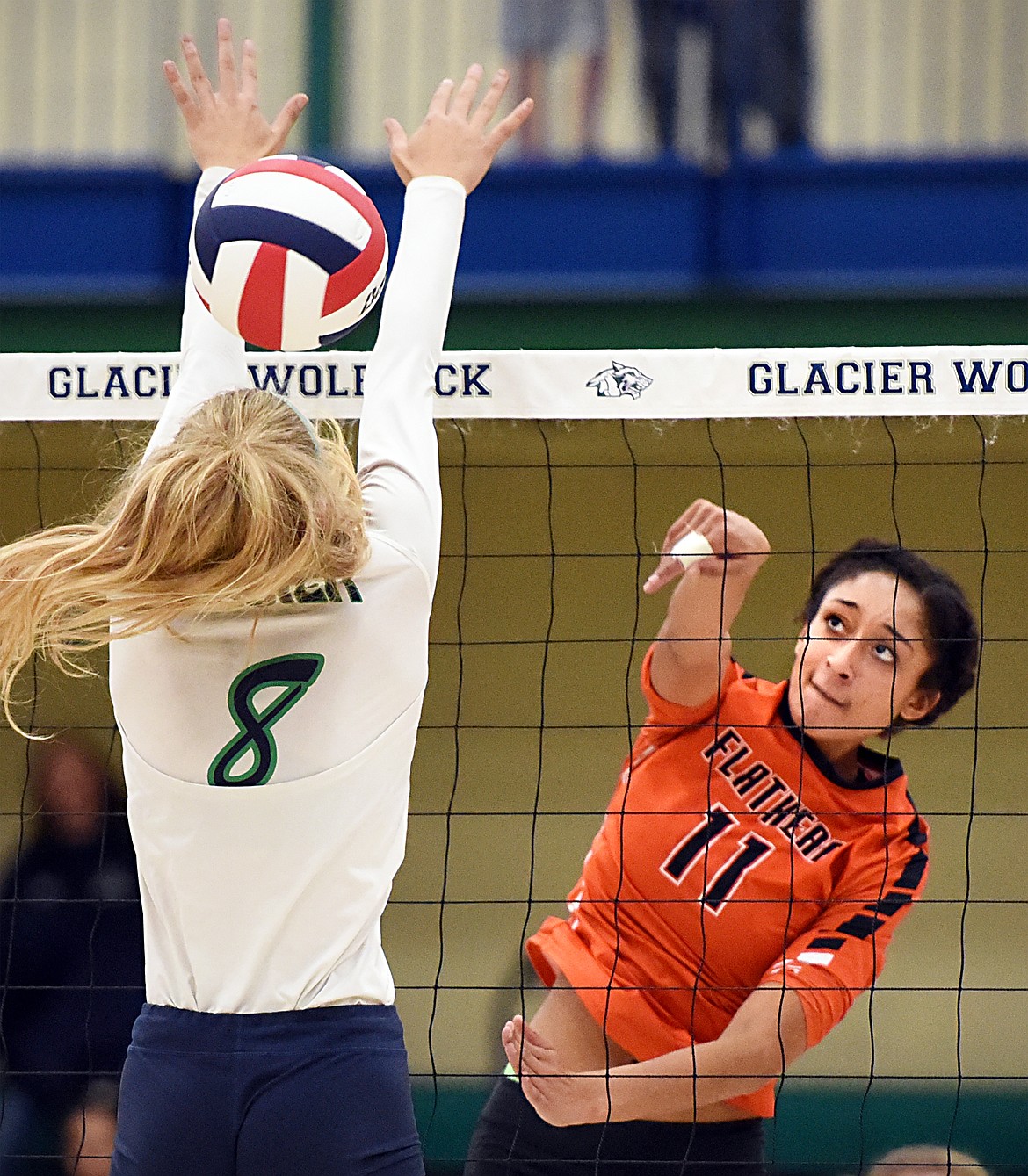 Flathead's Kaitlyn Kalenga (11) spikes past Glacier's Aubrie Rademacher (8) during crosstown volleyball at Glacier High School on Thursday. (Casey Kreider/Daily Inter Lake)