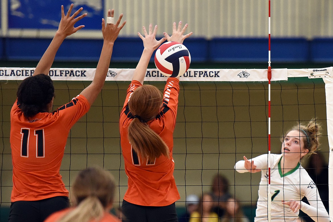 Glacier's Sidney Gulick (1) spikes past Flathead's Kaitlyn Kalenga (11) and Mayson Moore (17) during crosstown volleyball at Glacier High School on Thursday. (Casey Kreider/Daily Inter Lake)