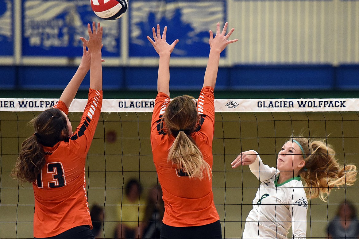 Glacier's Aubrie Rademacher (8) goes for a kill against Flathead's Maddi Chavez (13) and Kenna Johnson (3) during crosstown volleyball at Glacier High School on Thursday. (Casey Kreider/Daily Inter Lake)