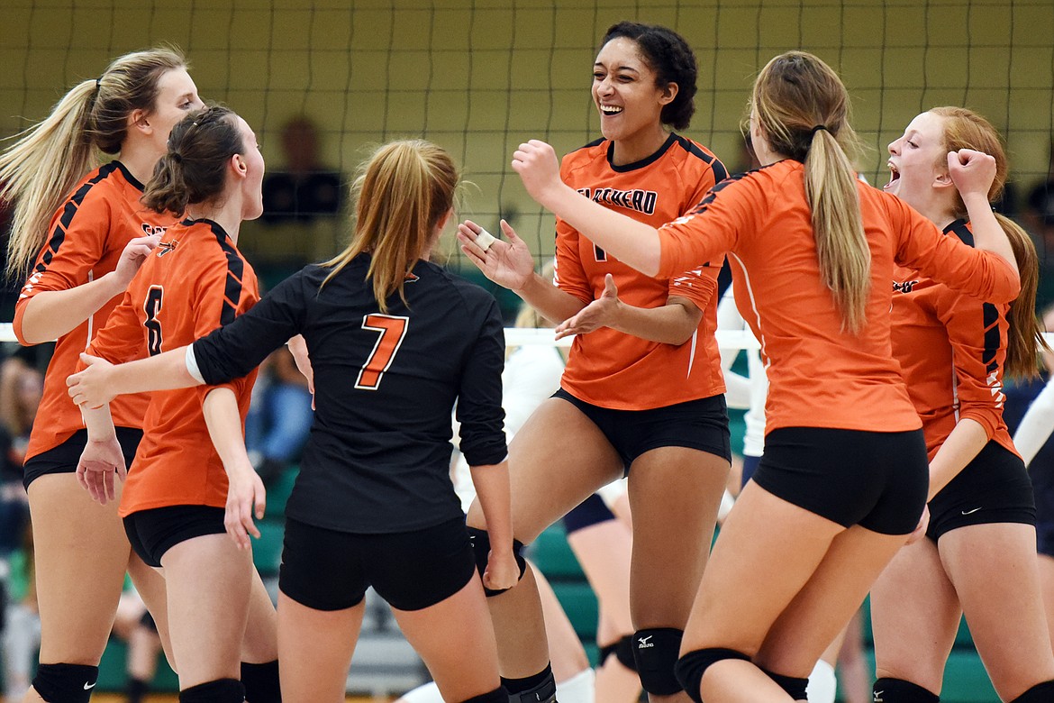 From left, Flathead's Julia Burden (22), Maddie Lindbom (6), Alayna Creekmore (7), Kaitlyn Kalenga (11), Kenna Johnson (3) and Mayson Moore (17) celebrate after a point against Glacier during crosstown volleyball at Glacier High School on Thursday. (Casey Kreider/Daily Inter Lake)
