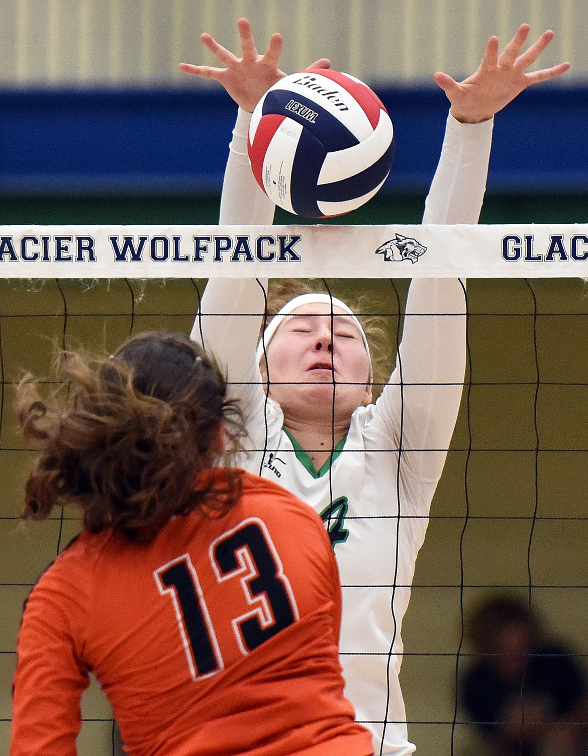 Glacier's Emma Anderson (14) blocks the spike of Flathead's Maddie Chavez (13) during crosstown volleyball at Glacier High School on Thursday. (Casey Kreider/Daily Inter Lake)