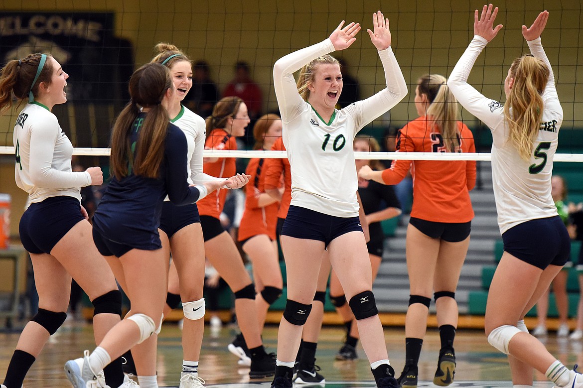 From left, Glacier's Kacey Hill (4), Alyssa AuClaire (11), Sidney Gulick (1), Kynzie Mohl (10) and Kaylee Fritz (5) celebrate after a point against Flathead during crosstown volleyball at Glacier High School on Thursday. (Casey Kreider/Daily Inter Lake)