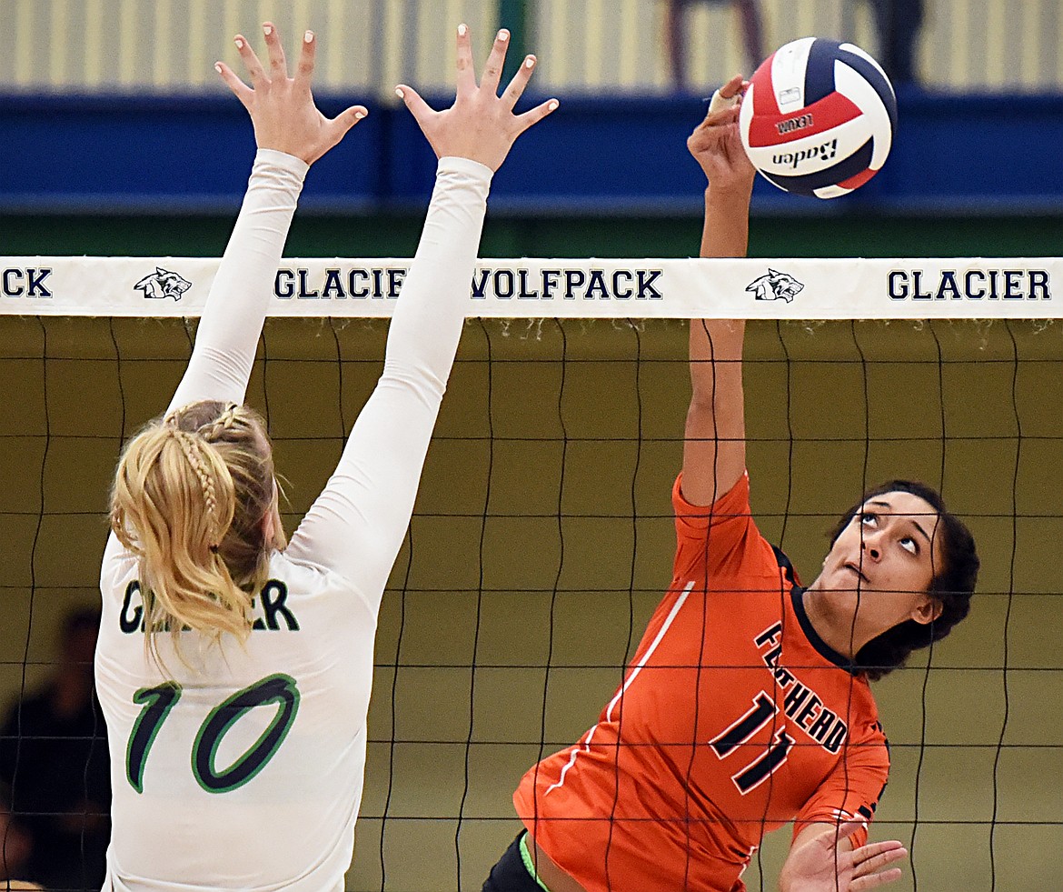 Flathead's Kaitlyn Kalenga (11) spikes past Glacier's Kynzie Mohl (10) during crosstown volleyball at Glacier High School on Thursday. (Casey Kreider/Daily Inter Lake)