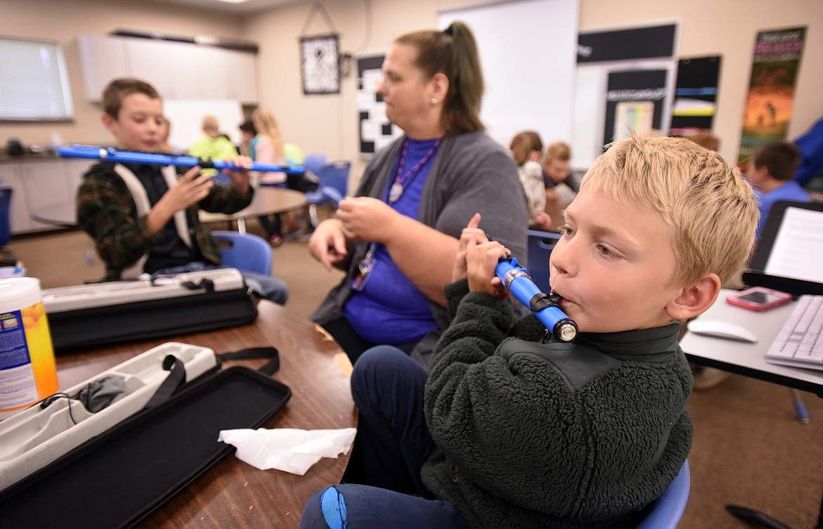 Fourth-graders Will Haller, front, and Owen Hadley, background, practice with two flutes purchased with money raised through online crowdfunding in Jennifer Murrell&#146;s class on Friday, Sept. 20, at Cayuse Prairie. The class was working on an exercise called stations, where the room is divided into fourths and students rotate through different musical exercises. Murrell said her goal is to give the students an introduction to music because in fifth grade they will decide if they want to continue with band or not. (Brenda Ahearn/Daily Inter Lake)