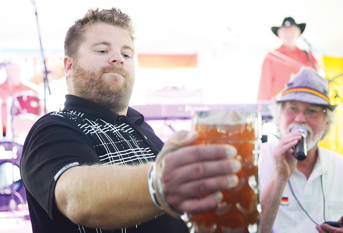 Austin Hoerner is the last man standing during a stein-holding contest Saturday at the Great Northwest Oktoberfest in Whitefish.
