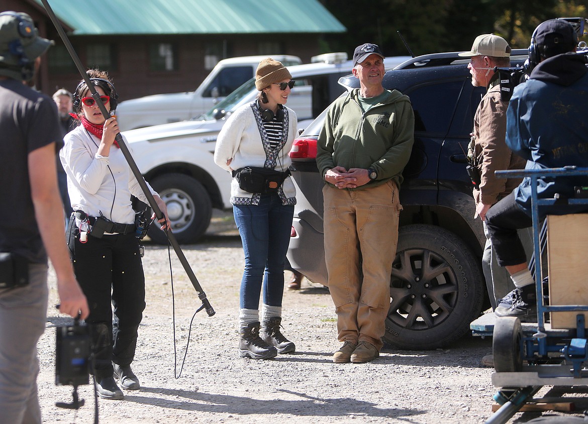 &#147;Cowboys&#148; director Anna Kerrigan, center, chats with actors and crew members between takes. (Mackenzie Reiss/Daily Inter Lake)