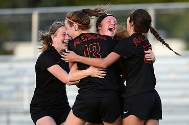 From left, Flathead's Lily Tanko (7), Tessa Smith (13), Skyleigh Thompson (9) and Ashlynn Whiteman (10) celebrate after Thompson's go-ahead goal in the second half against Glacier during crosstown soccer at Legends Stadium on Tuesday. (Casey Kreider/Daily Inter Lake)