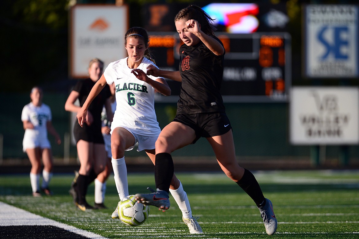 Glacier's Alma Patrick (6) and Flathead's Bridget Crowley (19) battle for a ball during crosstown soccer at Legends Stadium on Tuesday. (Casey Kreider/Daily Inter Lake)