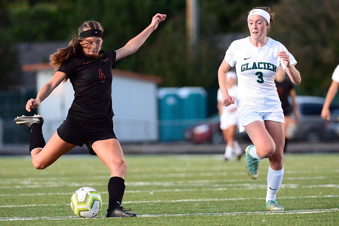 Flathead's Kami Darrow (4) gets off a shot in front of Glacier's Emma Paulson (3) during crosstown soccer at Legends Stadium on Tuesday. (Casey Kreider/Daily Inter Lake)
