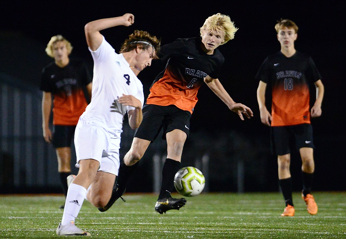 Flathead's Eric Gardner (6) pushes the ball upfield against Glacier's Braden Nitschelm (4) during crosstown soccer at Legends Stadium on Tuesday. (Casey Kreider/Daily Inter Lake)