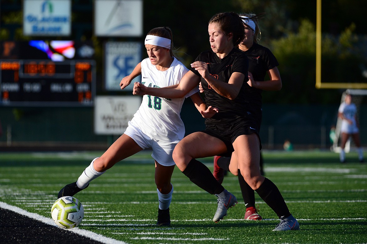 Glacier's Madison Becker (18) battles Flathead's Bridget Crowley (19) for the ball during crosstown soccer at Legends Stadium on Tuesday. (Casey Kreider/Daily Inter Lake)