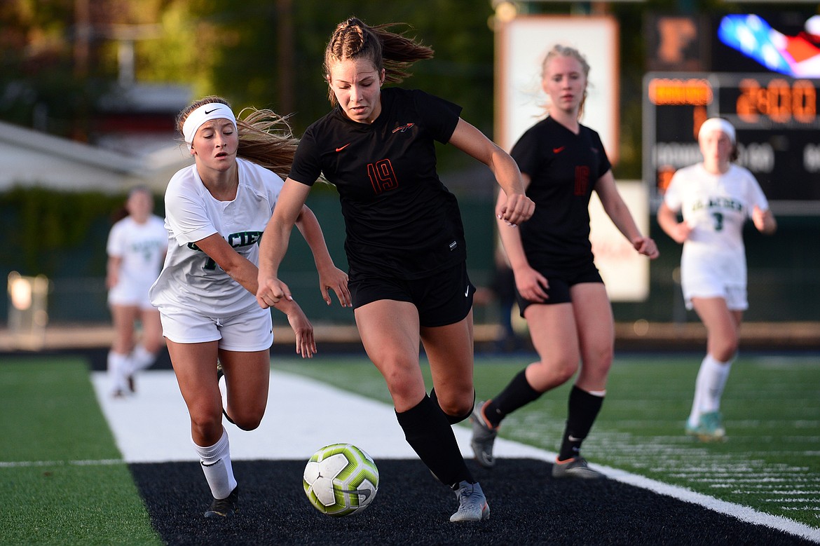 Glacier's Madison Becker (18) and Flathead's Bridget Crowley (19) battle for a ball during crosstown soccer at Legends Stadium on Tuesday. (Casey Kreider/Daily Inter Lake)