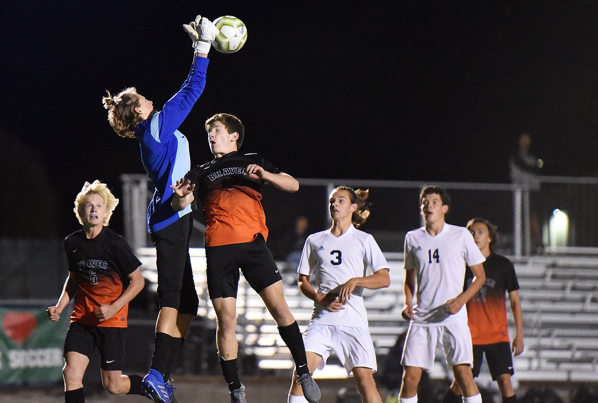 Glacier goalkeeper John Pyron (1) makes a save over Flathead's Fin Nadeau (2) in the first half during crosstown soccer at Legends Stadium on Tuesday. (Casey Kreider/Daily Inter Lake)