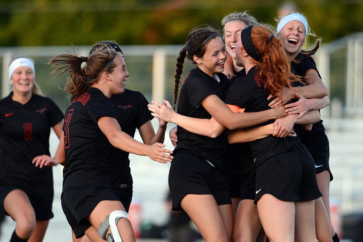 Flathead celebrates with Skyleigh Thompson (9) after Thompson's go-ahead goal in the second half against Glacier during crosstown soccer at Legends Stadium on Tuesday. (Casey Kreider/Daily Inter Lake)