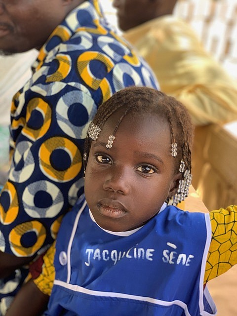 One of the first girls to receive a uniform.