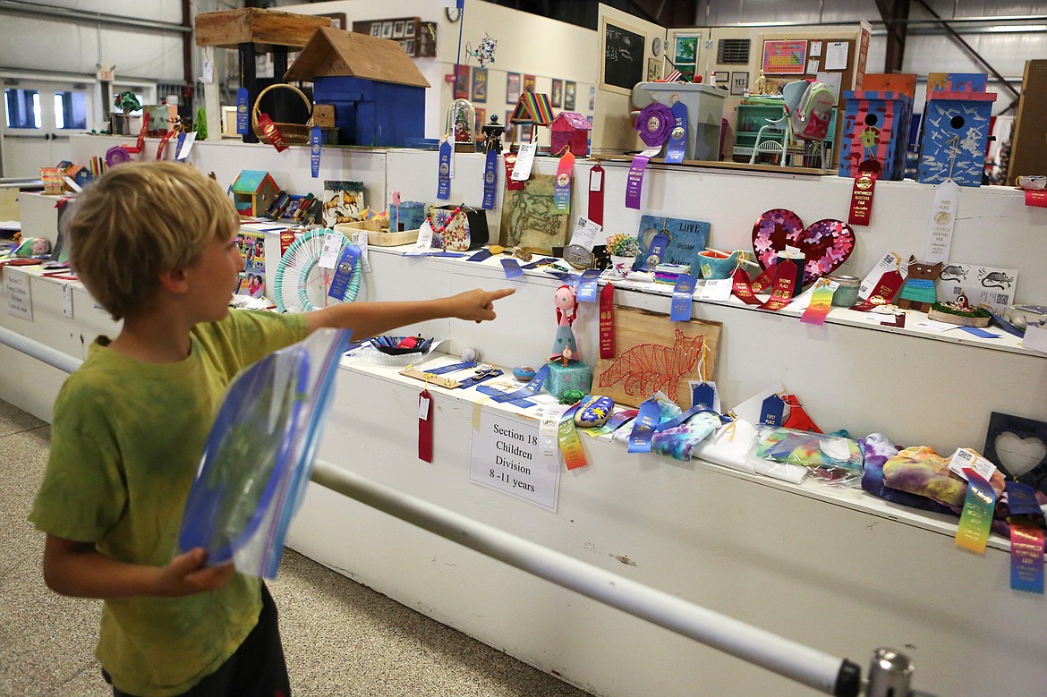 Jacob Linden, 9, points out a few of his exhibits inside the Expo Building at the Northwest Montana Fair in August.  (Daily Inter Lake file photo)