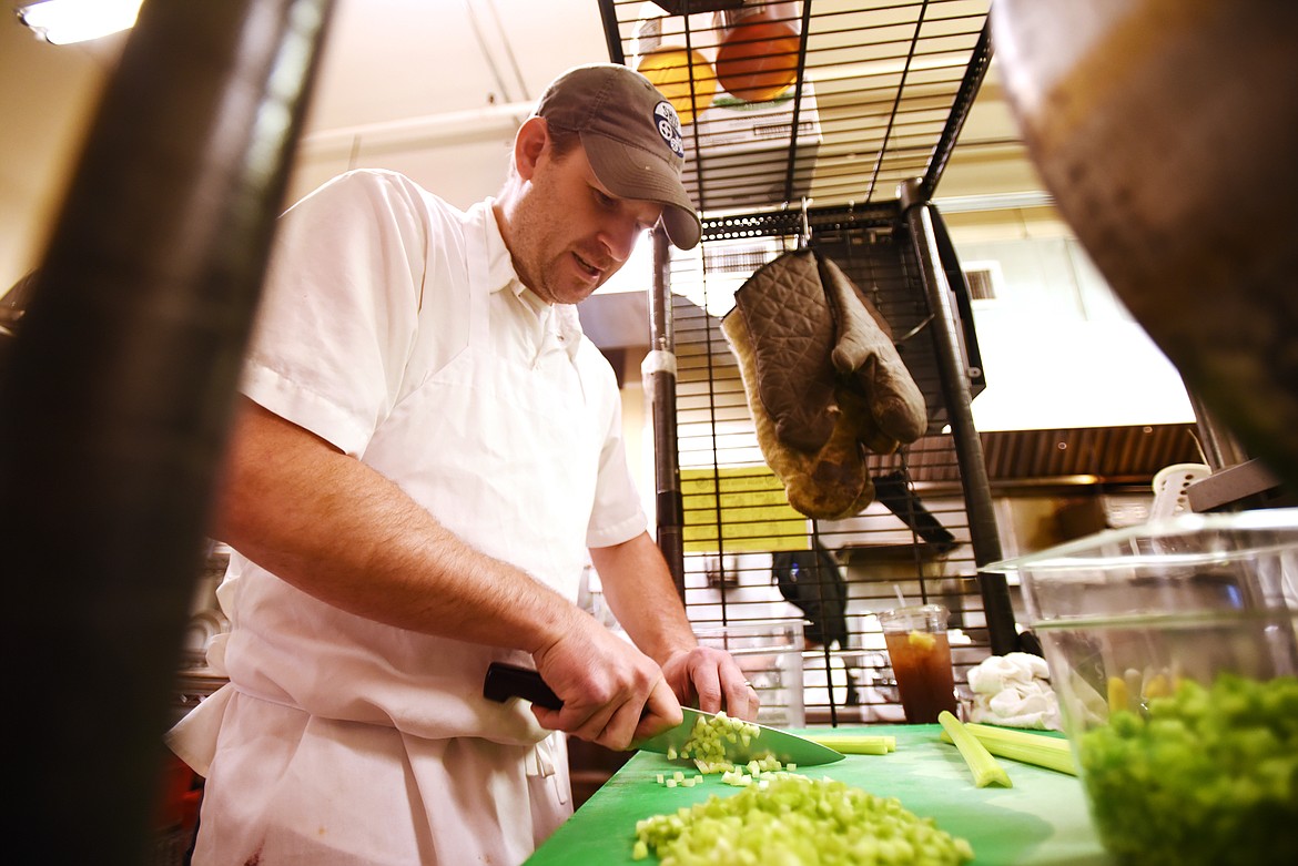 Shaun McCollum, general manager and executive chef at Loula's chops celery as he prepares to make gumbo on Thursday morning, September 19. McCollum said Loula's had to reduce their hours to only serve breakfast and lunch because they could not get enough staff to keep the restaurant open all day.(Brenda Ahearn/Daily Inter Lake)