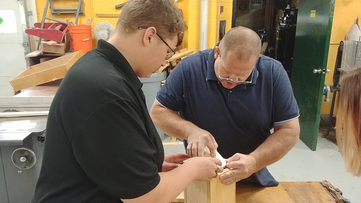 ST. REGIS Shop class instructor George Cheeseman is working with Damin Spoon, a freshman in wood shop. (Chuck Bandel/Mineral Independent)