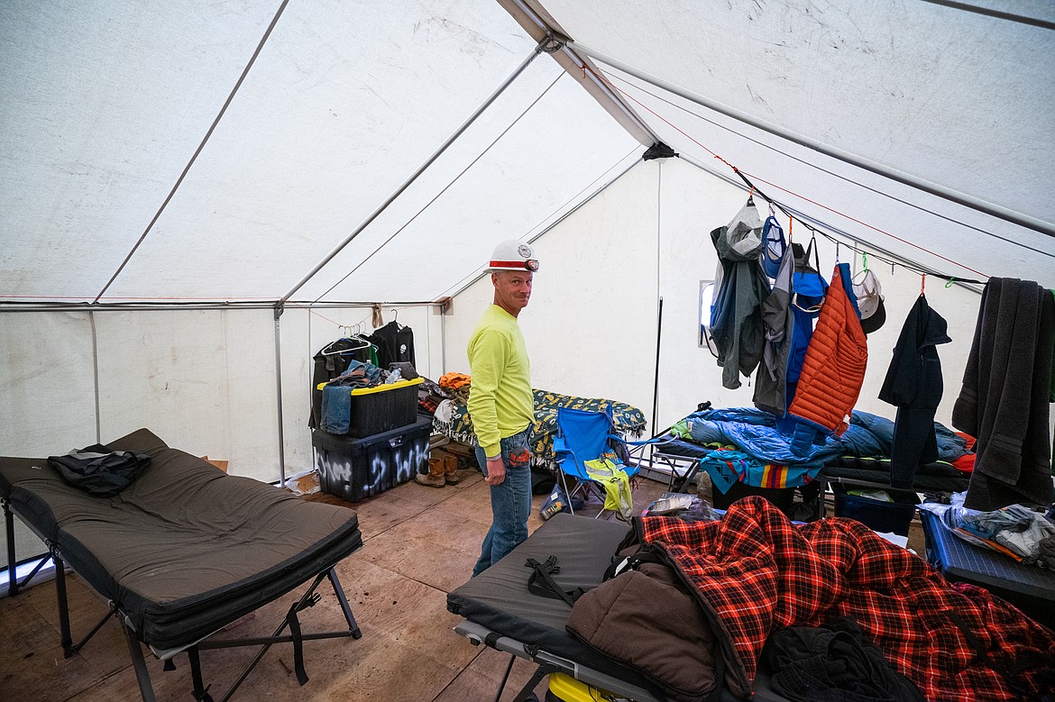 Kameron, a masonry worker on the Sperry Chalet, shows the photographer around his tent. (Daniel McKay/Whitefish Pilot)