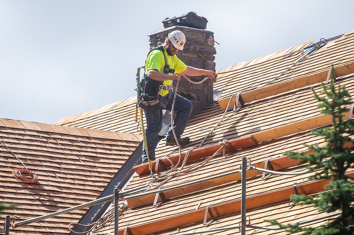 A Dick Anderson employee works on the roof of the Sperry Chalet in Glacier National Park. (Daniel McKay/Whitefish Pilot)