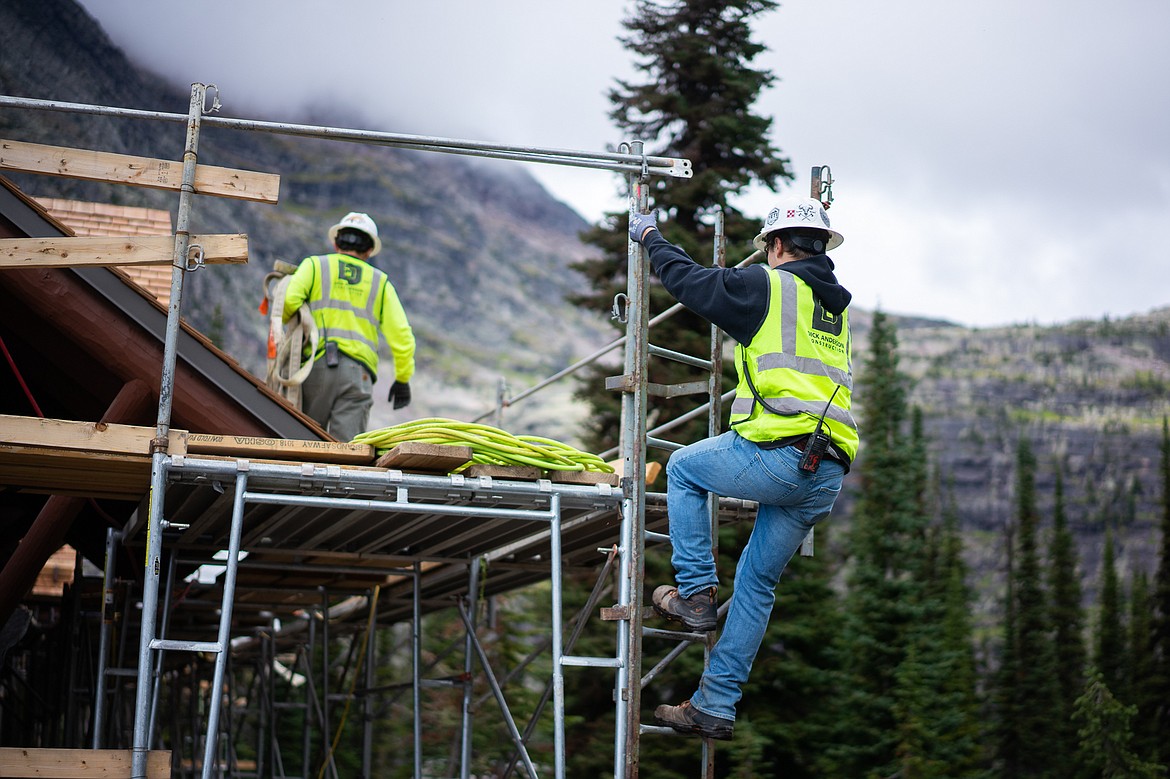 A construction worker climbs the scaffolding during restoration work at the Sperry Chalet in Glacier National Park. (Daniel McKay/Whitefish Pilot)