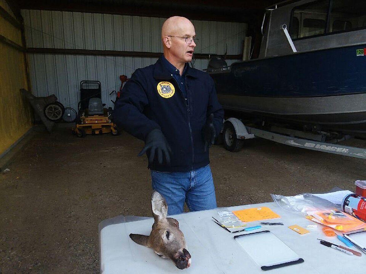 MONTANA FISH, Wildlife and Parks Region 1 Wildlife Program Manager Neil Anderson explains to Montana state legislators how FWP staff members collect samples from white-tailed deer to determine if they have chronic wasting disease. So far, 10 whitetails have been found to have CWD in the Libby Management Zone. (Scott Shindledecker/The Western News)