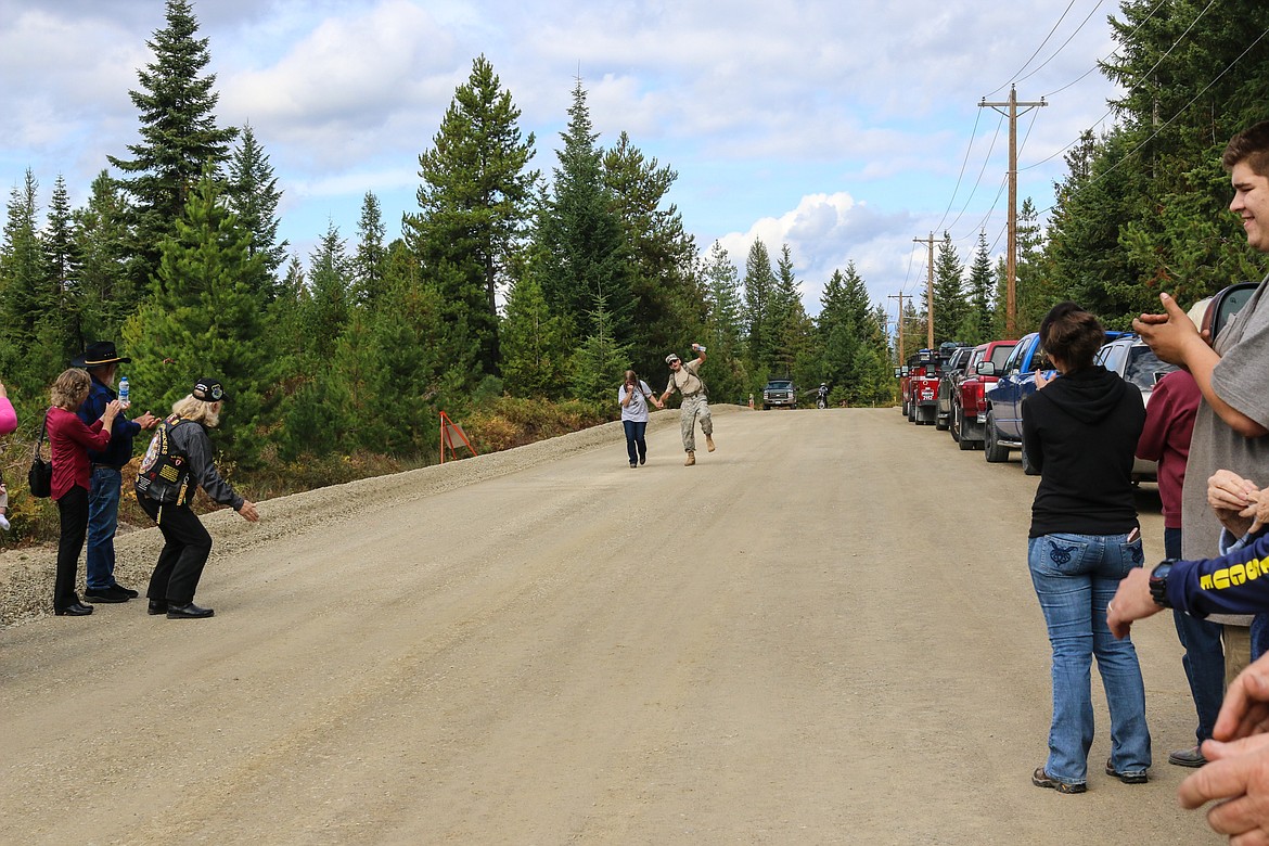 Photo by MANDI BATEMAN
Terry Brannon and retired Army Col. Dan Kern finishing the march to the cheers of the crowd.