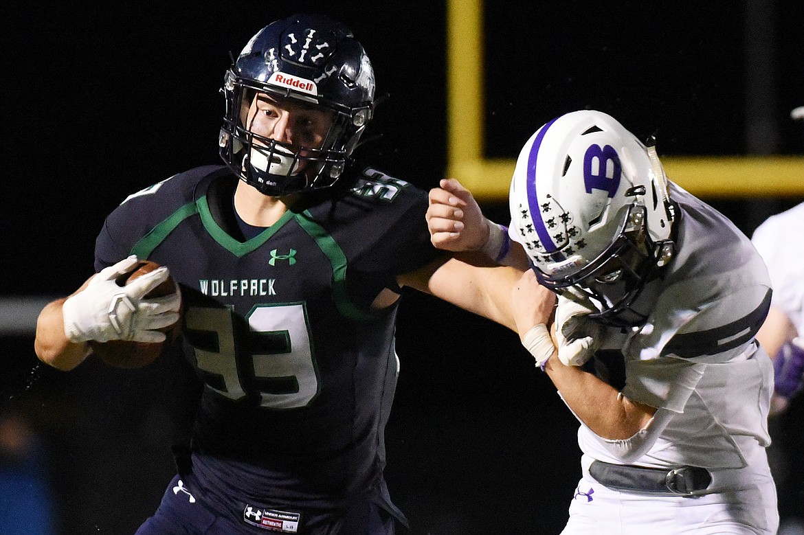 Glacier running back Jake Rendina (33) stiff arms Butte defensive back Tanner Huff (21) on a third quarter run at Legends Stadium on Friday. (Casey Kreider/Daily Inter Lake)