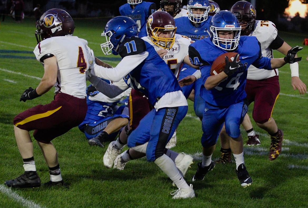 Casey McCarthy/Columbia Basin Herald Cael Cox rushes behind a blocker amidst a pile of players during the Cougars&#146; 56-0 win over Cle Elum-Roslyn on Friday.