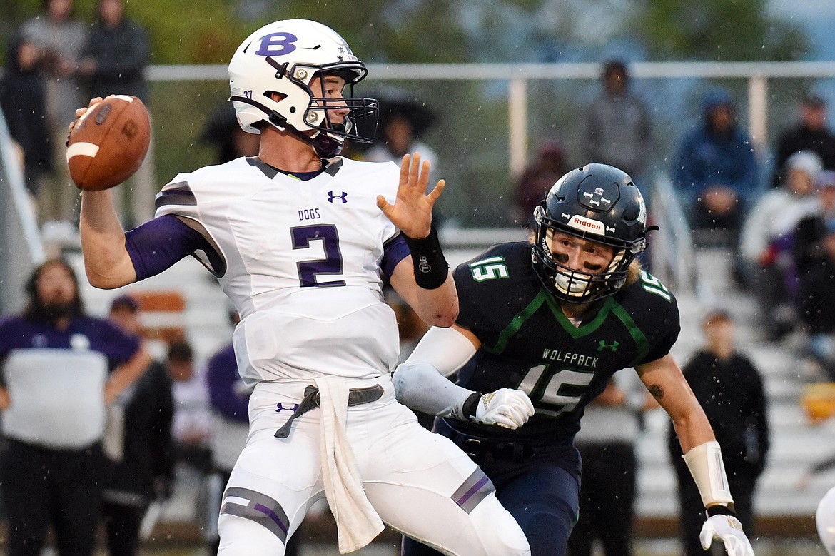 Butte quarterback Tommy Mellott (2) throws under pressure from Glacier linebacker Hunter Karlstad (15) in the first quarter at Legends Stadium on Friday. (Casey Kreider/Daily Inter Lake)