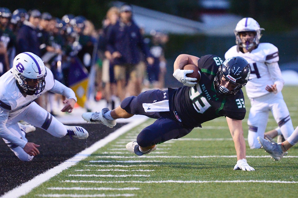 Glacier running back Jake Rendina (33) dives for extra yardage on a first-quarter run against Butte at Legends Stadium on Friday. (Casey Kreider/Daily Inter Lake)