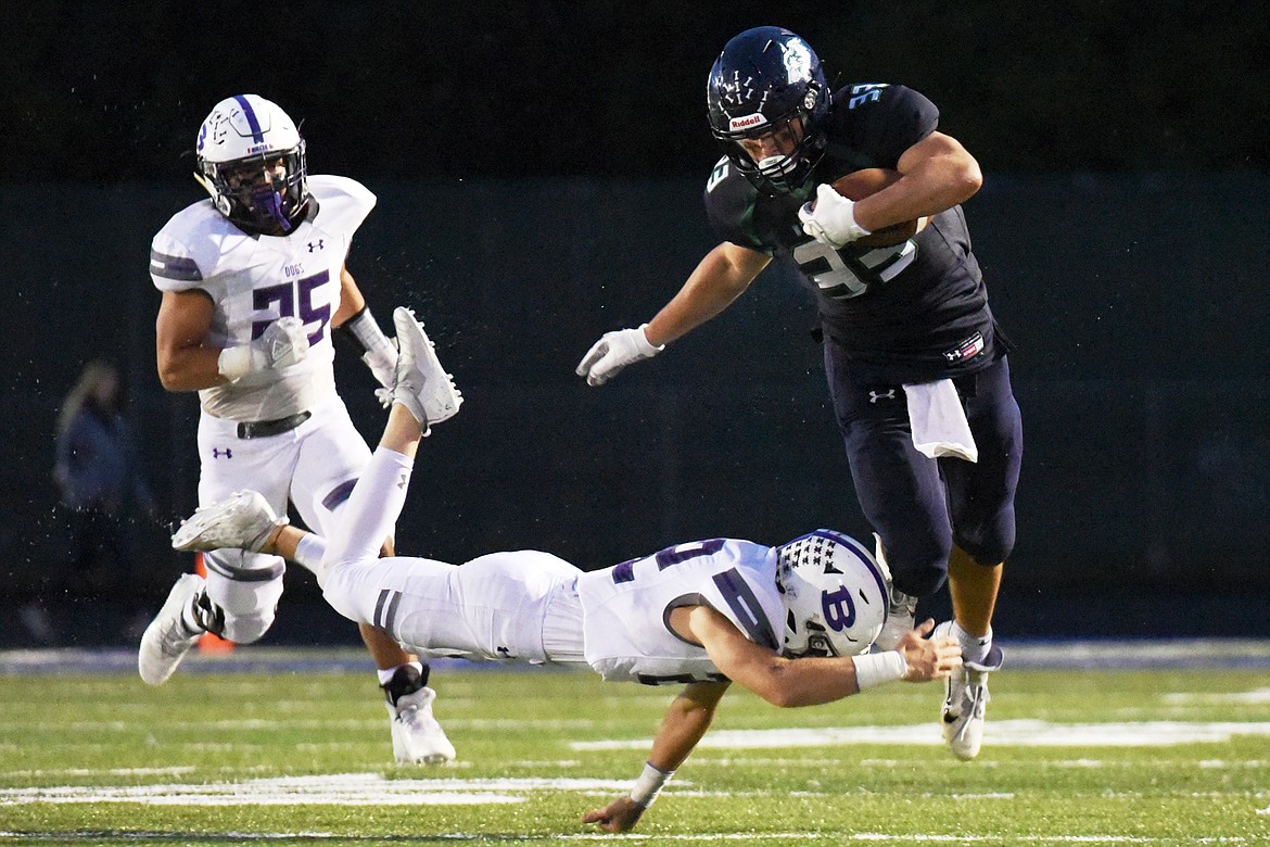 Glacier running back Jake Rendina (33) is tripped up by Butte defensive back Scout Allen (22) at Legends Stadium on Friday. (Casey Kreider/Daily Inter Lake)