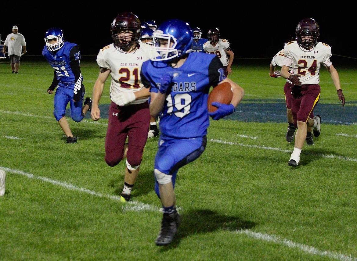 Casey McCarthy/Columbia Basin Herald  Garrett Chamberlain rushes forward for the Cougars on Friday night at Warden High School