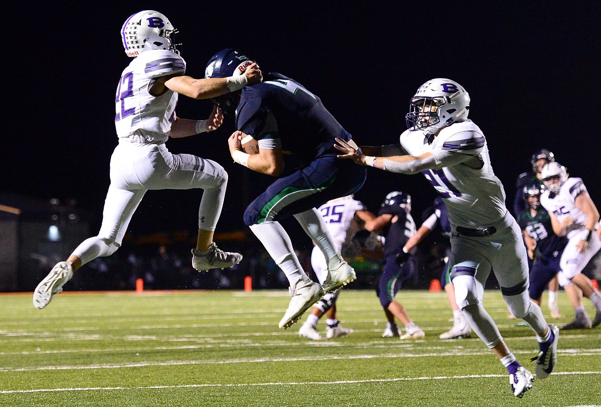 Glacier wide receiver Luke Bilau (4) catches a pass between Butte defensive backs Scout Allen (22) and Tanner Huff (21) in the second quarter at Legends Stadium on Friday. (Casey Kreider/Daily Inter Lake)