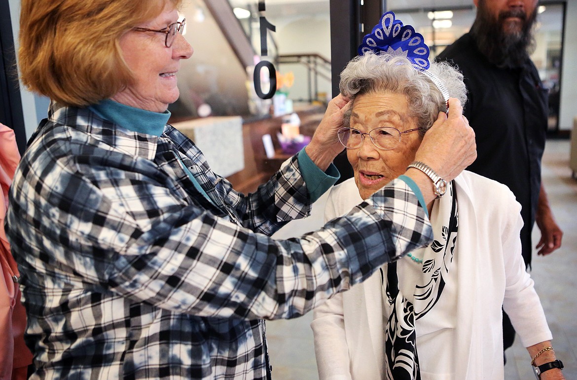 Kalispell Senior Center member Karen Bronderslev gives Kaye Stevens, 95, a crown for a party held to honor the center&#146;s members 90 years of age and older.