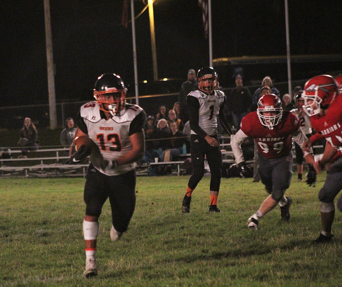 ESVIN REYES (13) taking a hand-off from Treydon Brouillette (#1). (John Dowd/ Clark Fork Valley Press)