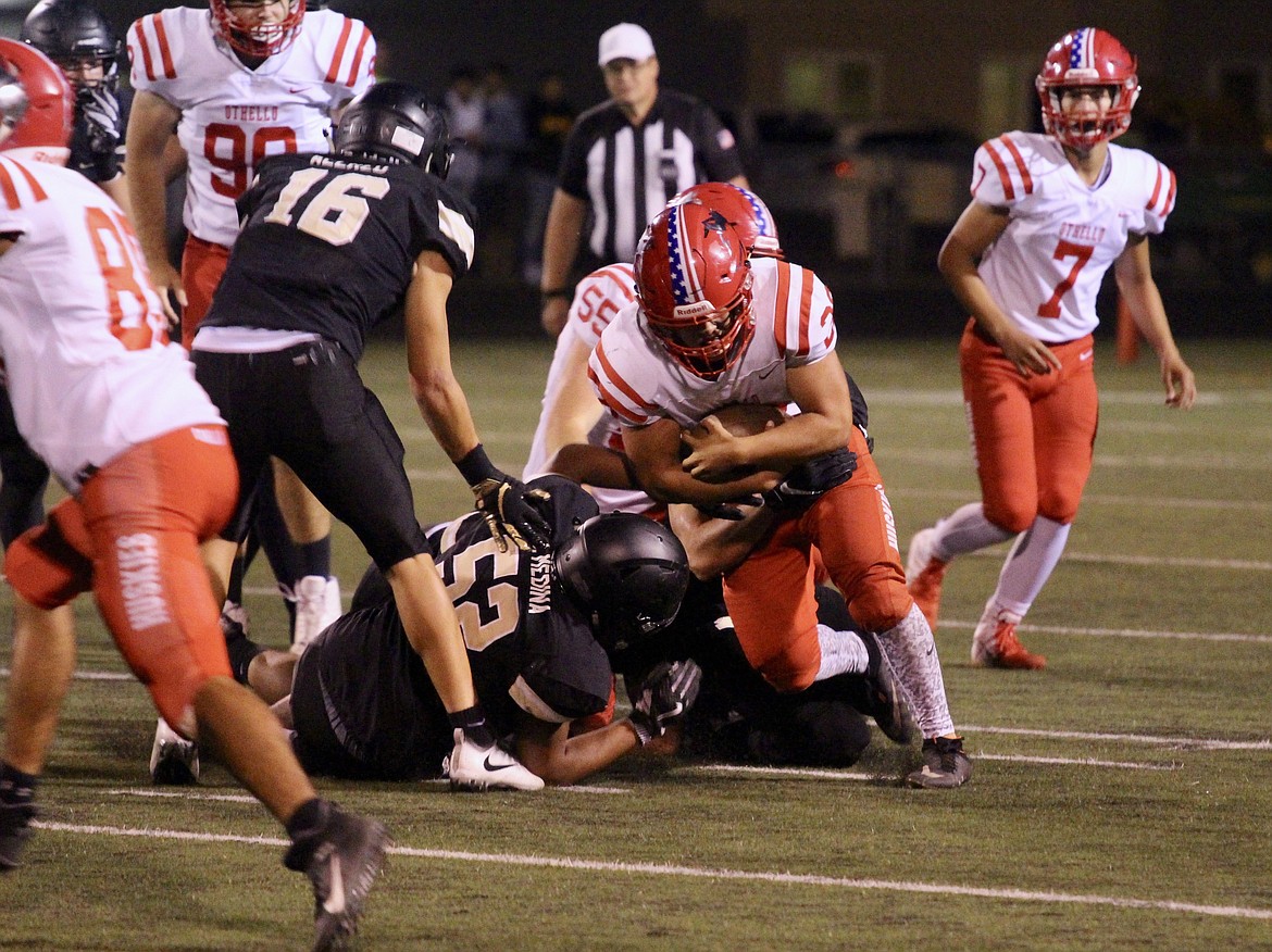 Casey McCarthy/ Columbia Basin Herald The Royal defense collapses on the Othello rusher as he tries to push his way forward on Friday night in Royal City.