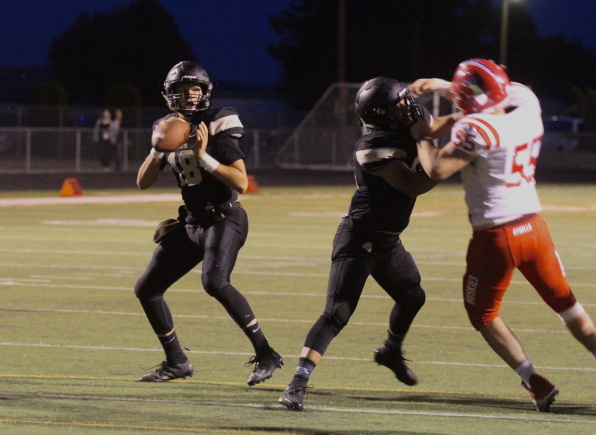 Casey McCarthy/ Columbia Basin Herald Royal High School quarterback Caleb Christensen surveys the endzone against Othello. Christensen finished with 4 TD&#146;s in the game.