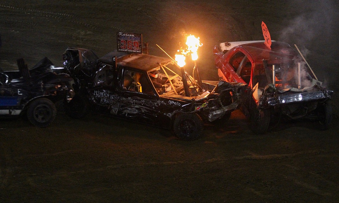 Casey McCarthy/ Columbia Basin Herald Karson Dockins, #369, gets sandwiched in between two drivers during the Demolition Derby on Wednesday night in Othello.