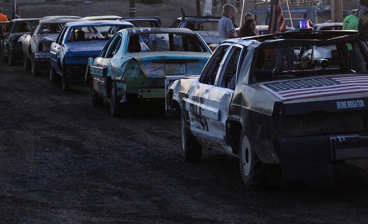 Casey McCarthy/ Columbia Basin Herald Cars line up outside the arena on Wednesday night as they wait for their race to begin at the Othello Demolition Derby.