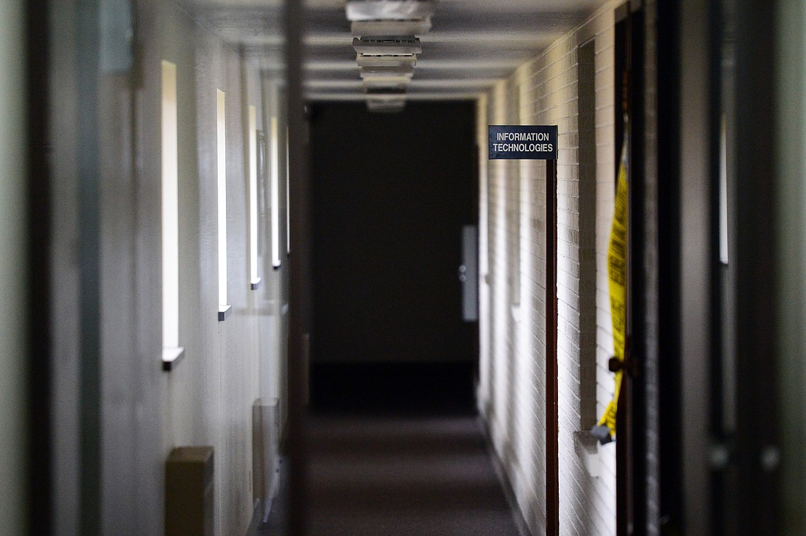 Yellow tape hangs along the wall of a hallway inside a remaining administration building at the Columbia Falls Aluminum Co. on Wednesday, Sept. 18. (Casey Kreider/Daily Inter Lake)