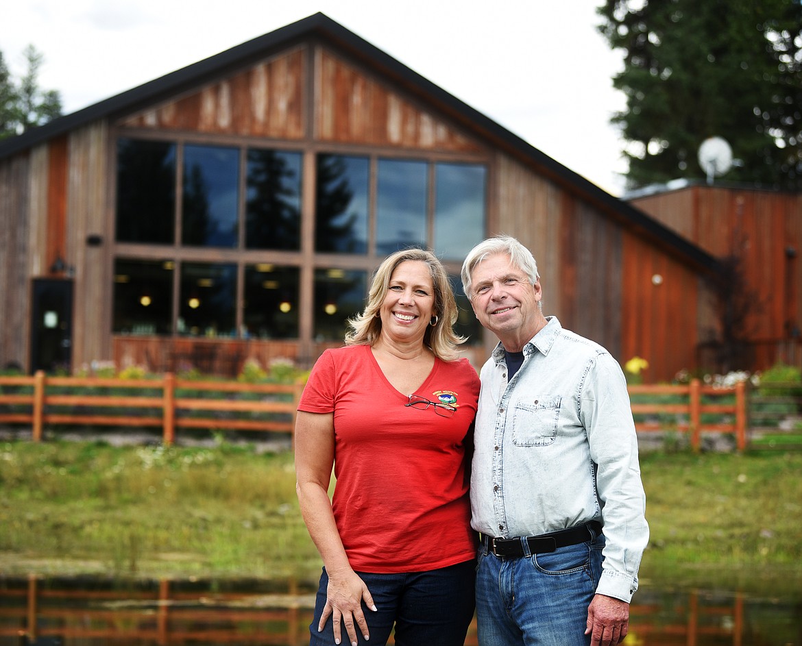 Owners Grace Siloti and Len Kobylenski pose behind the Mission Mountain Mercantile on Sept. 13. The building was destroyed in a fire in 2016 and reopened in April 2018.