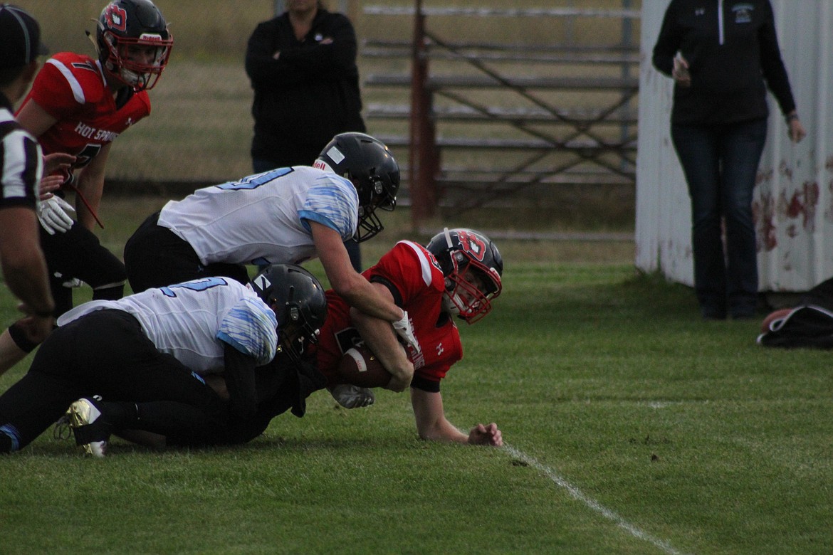 LUKE WATERBURY Crawling to gain just a yard more after being tackled, lastFriday in Hot Springs game against Shields Valley. (John Dowd/Clark Fork Valley Press)