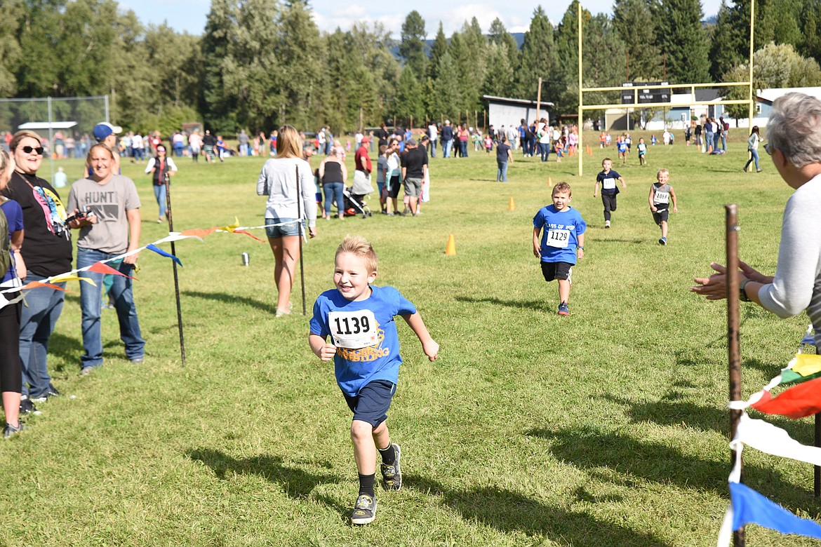 A HAPPY James Masters, 5, races to the finish line at the 30th Annual Runnerfell Sept. 13. (Scott Shindledecker/The Western News)